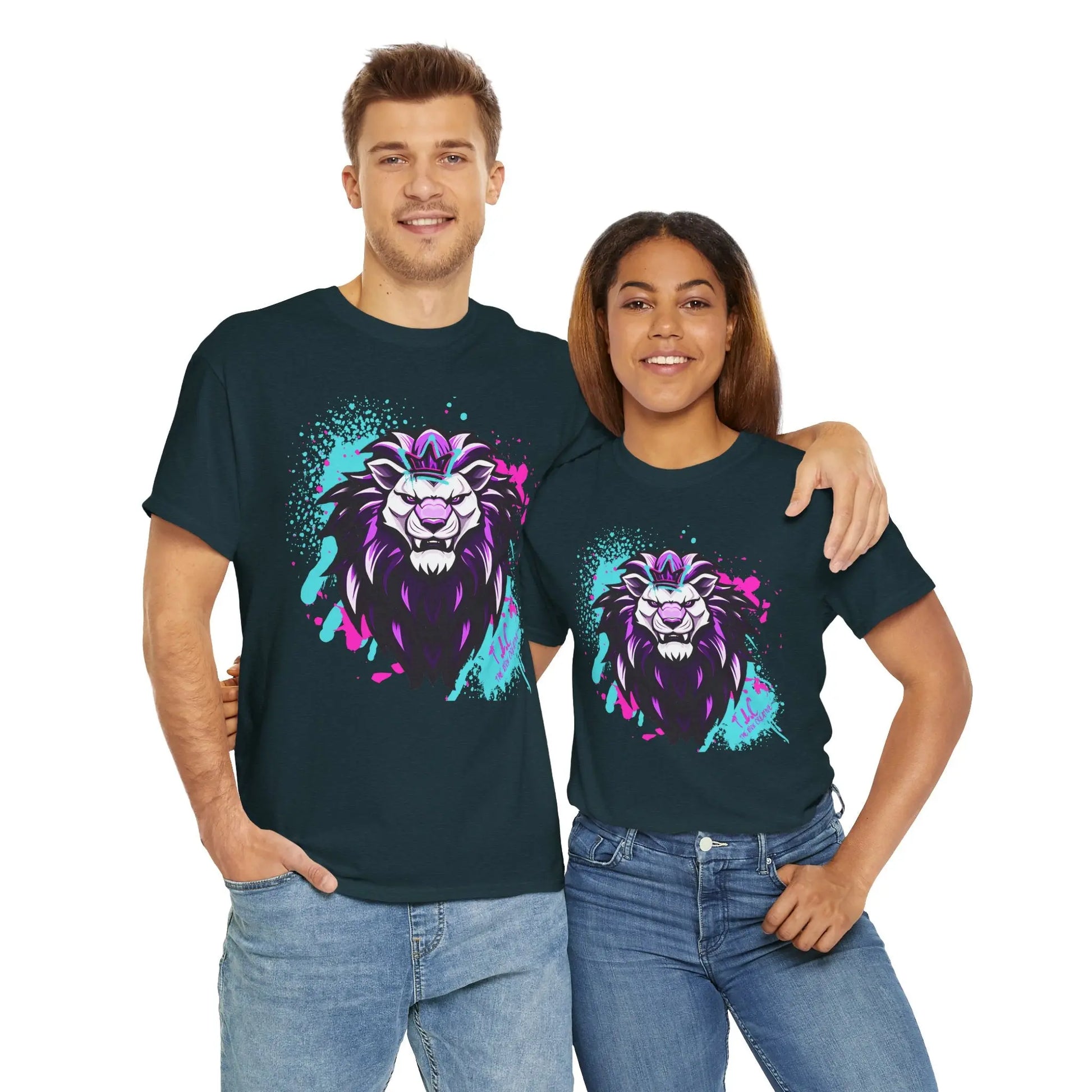 A man and a woman stand side by side, smiling in matching dark blue T-shirts made from 100% cotton, known as The Lyon T-shirt. Their shirts display a colorful, stylized lion design in pink, purple, and teal. With her arm around the man's back, both enjoy the comfort of the classic fit.