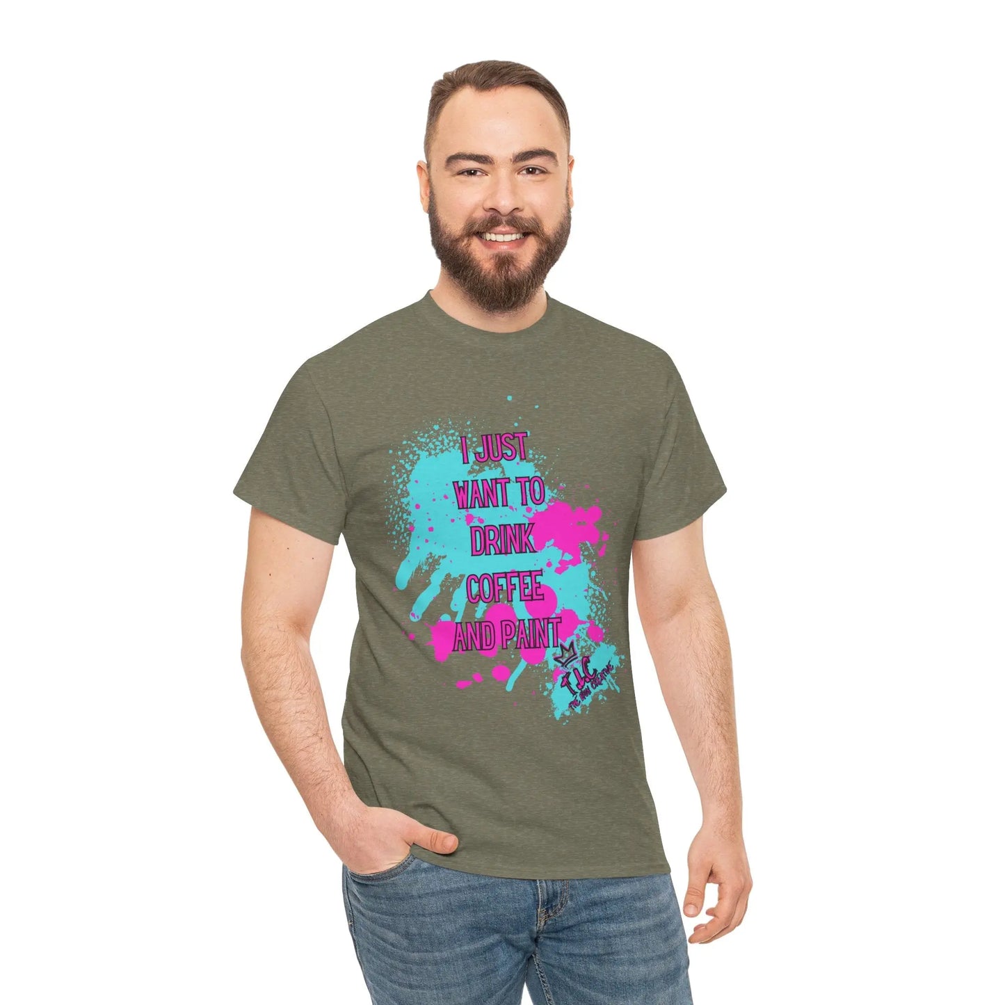 A bearded man sports an "I Just want to Drink Coffee" T-shirt, showcasing a classic fit made from sustainable cotton. The shirt features colorful splashes and the playful slogan, "I just want to drink coffee and paint." He smiles against a plain white background, effortlessly merging style with ethical production.