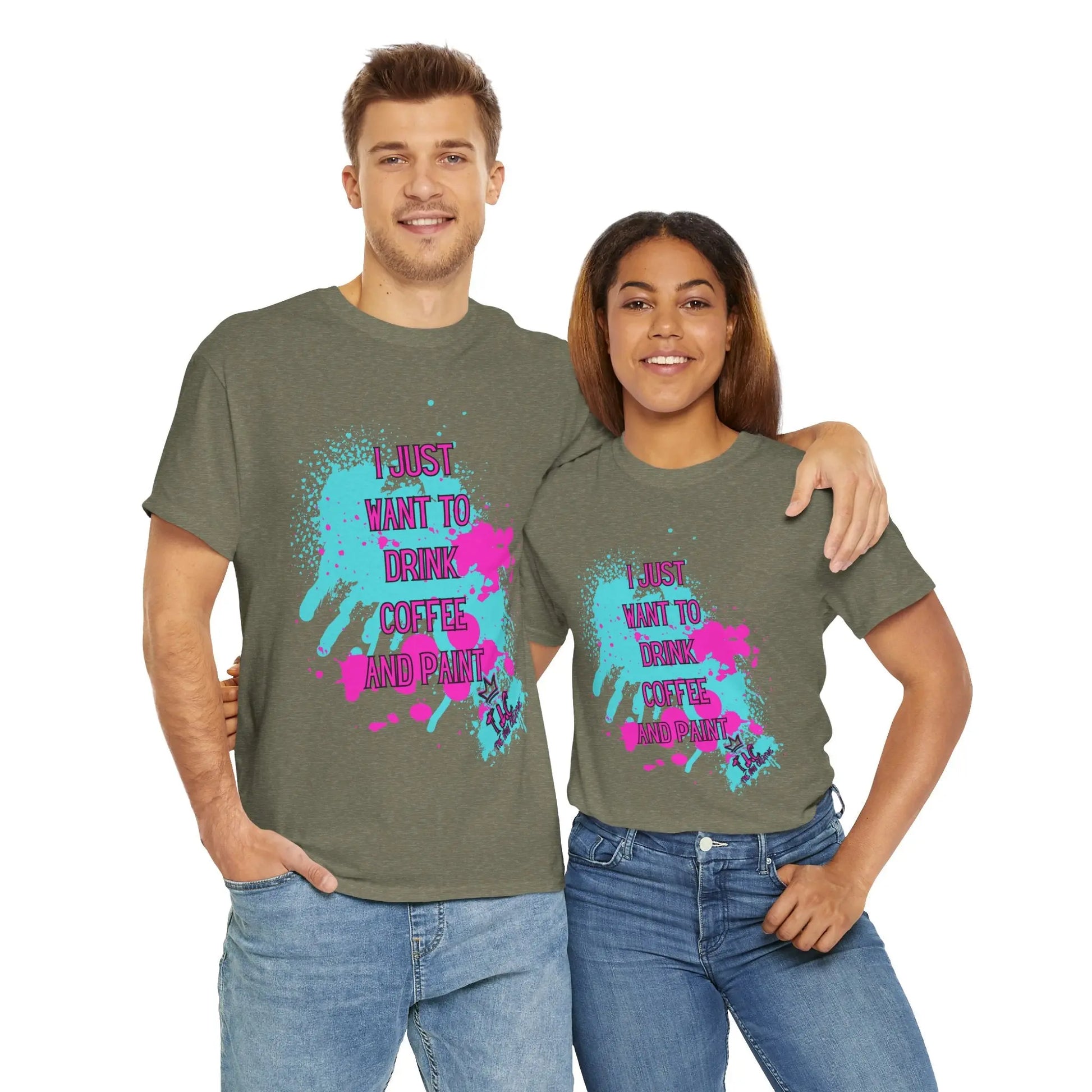 A man and a woman are side by side, both donning the "I Just Want to Drink Coffee" T-shirts. These classic-fit green tees, crafted from 100% cotton, feature vibrant paint splatter designs and the playful text "I Just Want to Drink Coffee and Paint." The man's arm is around the woman as they both share a smile.