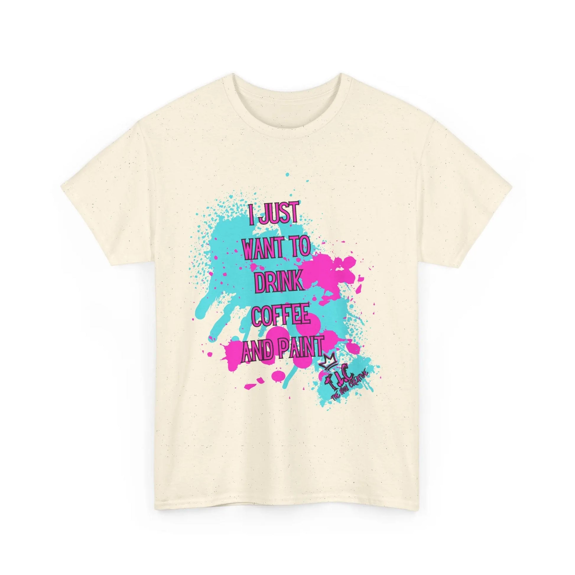 A classic fit I Just Want to Drink Coffee T-shirt in beige, made from 100% cotton. It features vibrant blue and pink paint splatters and displays the bold pink text "I JUST WANT TO DRINK COFFEE AND PAINT." A small paintbrush and palette graphic completes the design.