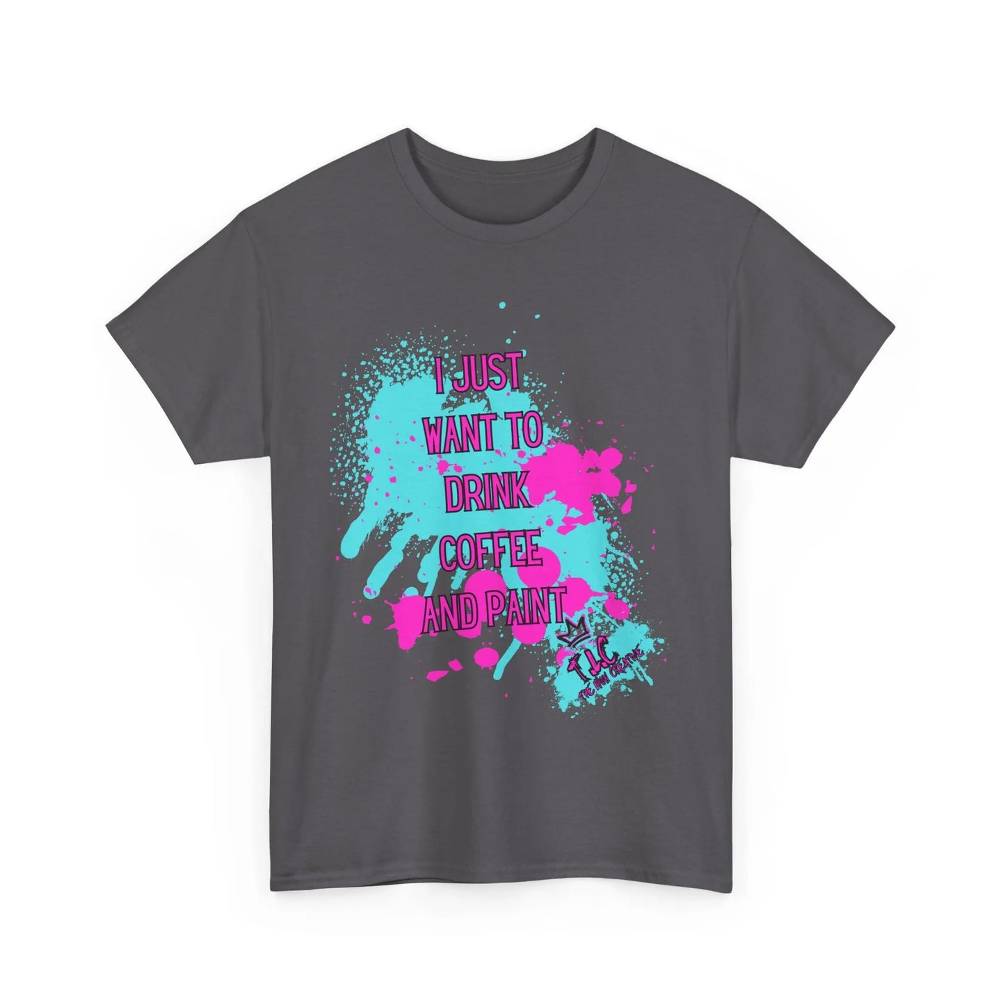 The "I Just Want to Drink Coffee" t-shirt is crafted from 100% cotton in a dark gray hue and showcases a vivid pink and light blue paint splatter design. Featuring fun text that reads, "I just want to drink coffee and paint," it combines style with sustainability, using ethically grown materials.