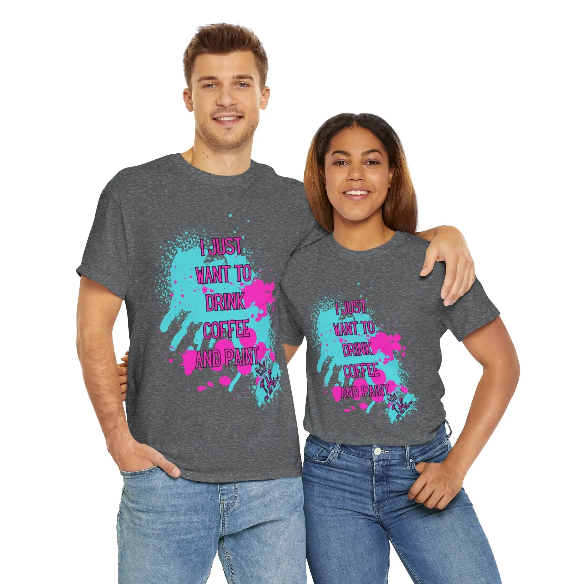 A man and a woman stand side by side, wearing matching gray cotton "I Just Want to Drink Coffee" T-shirts featuring colorful splatter designs. These classic fit tees highlight their commitment to sustainability in production methods.