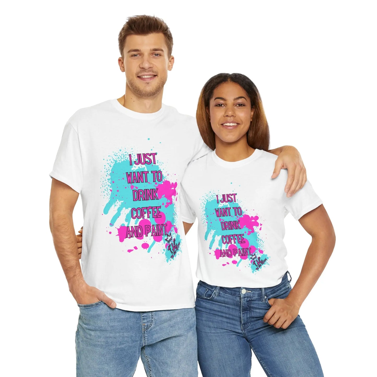 A man and woman stand together, each sporting the "I Just Want to Drink Coffee" T-shirt. The shirts feature vibrant splatter designs with the phrase "I just want to drink coffee and paint." They pose casually with smiles against a simple white background, highlighting their appreciation for sustainable fashion.