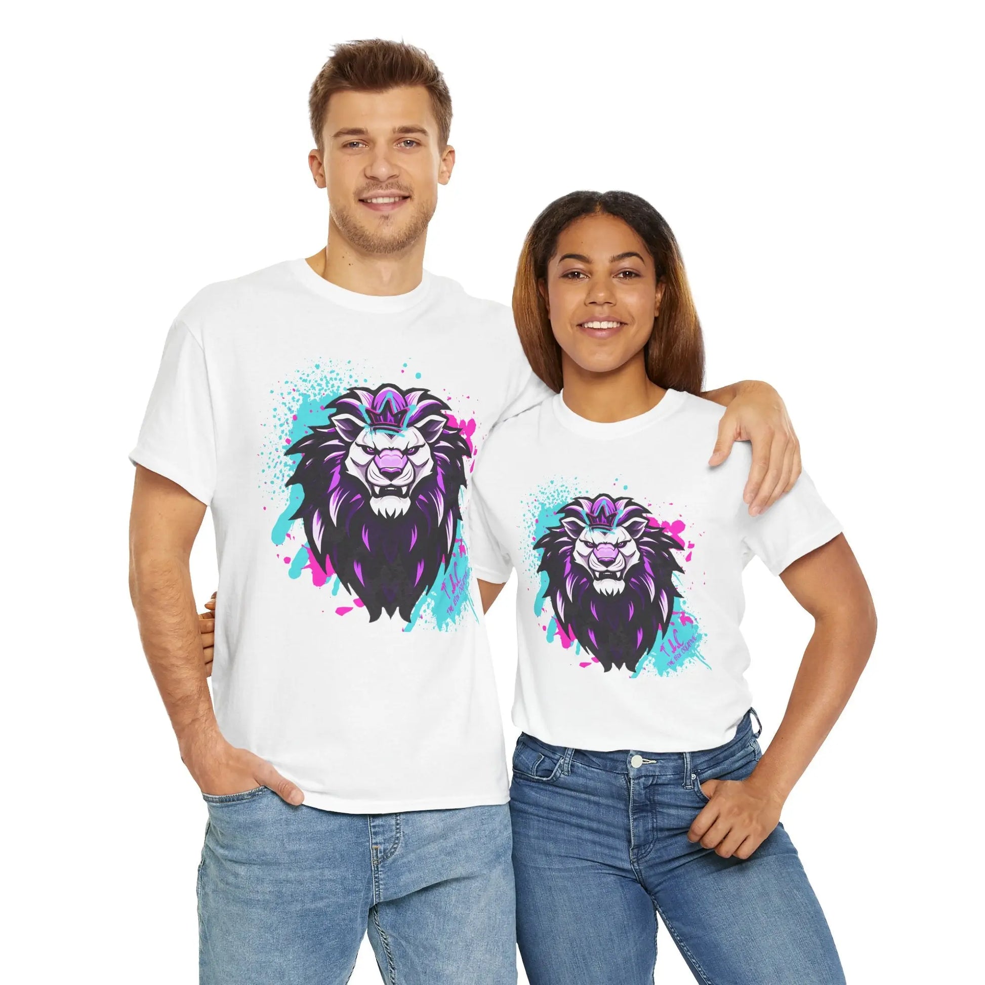 A man and a woman stand smiling, each wearing "The Lyon T-shirt," made from sustainable 100% cotton featuring a colorful lion graphic. The man has his arm around the woman as they both wear jeans and pose against a plain white background, highlighting their Oeko-Tex certified style.